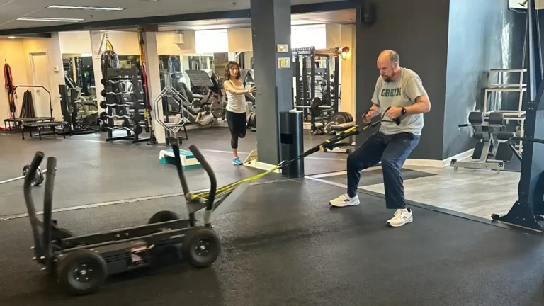 A man and woman are training under Mark's Guidance